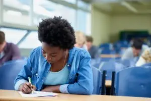 writing university black woman student classroom studying test exam assignment education college female person working project with knowledge lecture hall learning